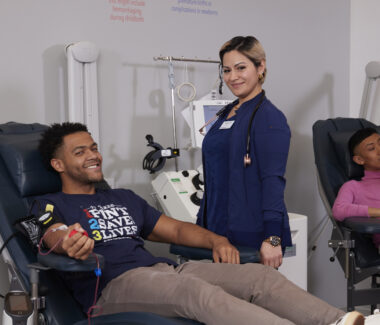 CTBC phlebotomist with blood donor in donation chair