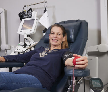 Smiling blood donor in donation chair at CTBC donation location.