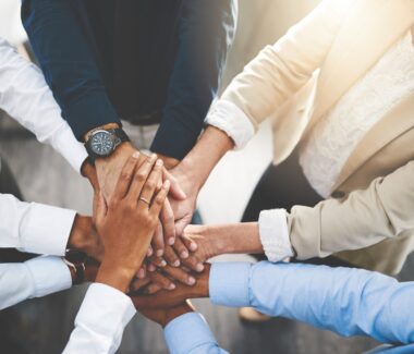 Hands stacked on top of each other indicating unity